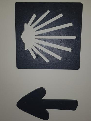 a black sign with a symbol of a wind at Hotel Malecon in O Barco de Valdeorras