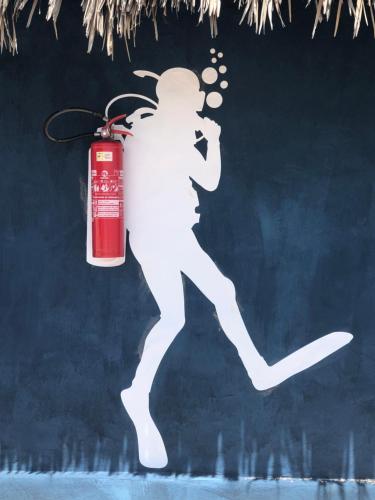 a christmas ornament of a woman running with a fire extinguisher at Cabana Chic Sunrise in Tatajuba