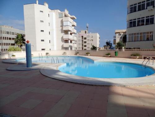 a large swimming pool with buildings in the background at Golden Blue Arenales in Arenales del Sol