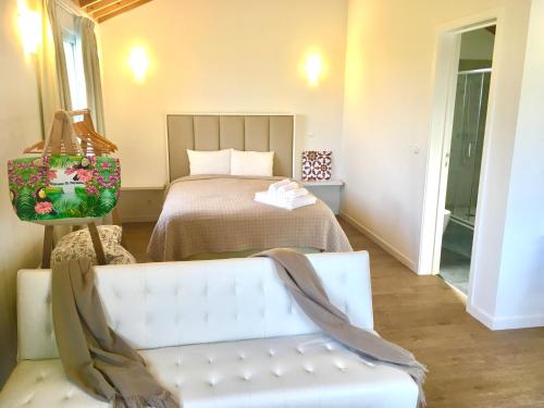 a bedroom with a bed and a bench in front of it at Azores Casa Hawaii in Nordeste