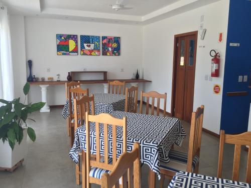 a dining room with a black and white table and chairs at The Hyperion Boutique Hotel in Florianópolis