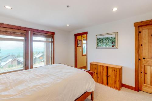 a bedroom with a bed and a large window at Towering Pines 2 in Big White
