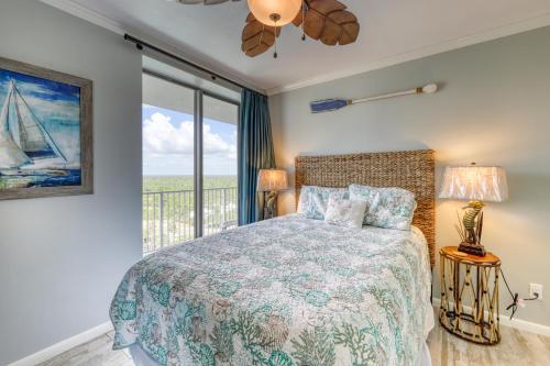 a bedroom with a bed and a large window at Bluewater Apartments in Orange Beach