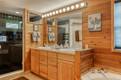 a bathroom with two sinks and a large mirror at Split Pine Cabin in Pagosa Springs