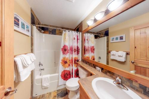 a bathroom with a sink and a toilet and a shower at Towering Pines 2 in Big White