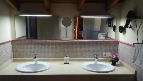 two sinks in a bathroom with two mirrors at Casa Doña Justa in Tegueste