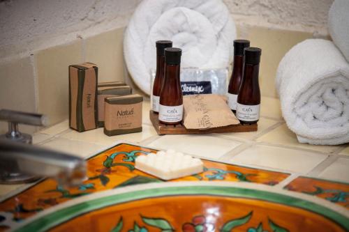 a bathroom counter with two bottles of soap and towels at Villa Blanca Huatulco in Santa Cruz Huatulco