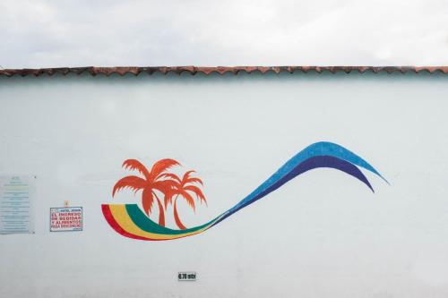 a kite with a palm tree on a wall at Hotel Joohn Gay only LGBTIQ in Melgar
