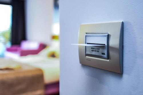 a lightswitch on a wall in a room at Hotel La Fiorita in Limone sul Garda