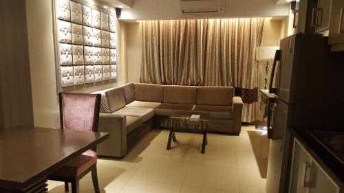 a living room with a couch and a table at Prime Asia Hotel in Angeles