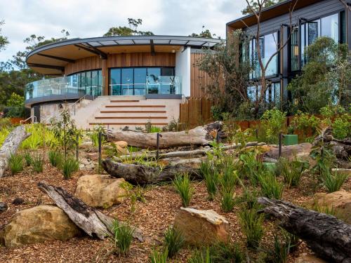 a house with a garden in front of it at Wildlife Retreat at Taronga in Sydney