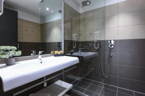 a bathroom with a sink and a shower at Hotel La Fiorita in Limone sul Garda