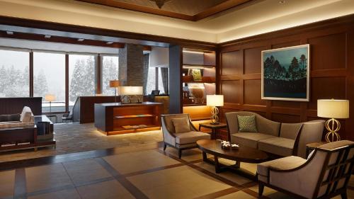 a living room with a couch and a table at Lotte Arai Resort in Myoko