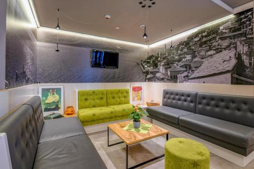 a waiting room with a couch and a table at Hotel La Fiorita in Limone sul Garda