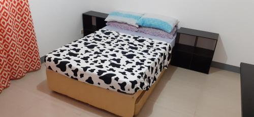a bedroom with a bed with black and white at Bella's Beach Resort (A) in Bauang