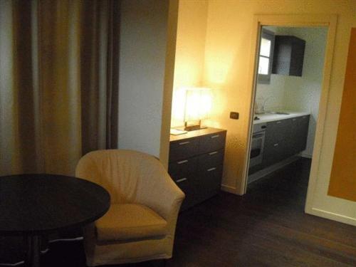 a room with a chair and a table and a sink at Joia Hotel & Luxury Apartments RTA in Brusaporto