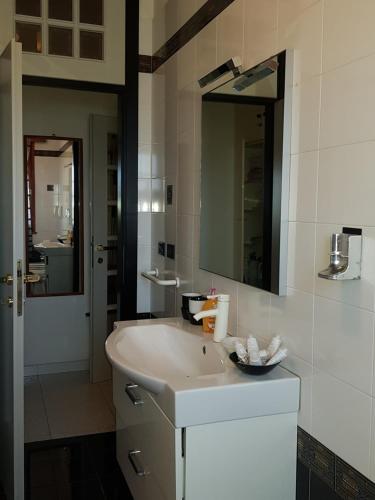 a bathroom with a white sink and a mirror at B&B da Silvana a Talamello in Talamello