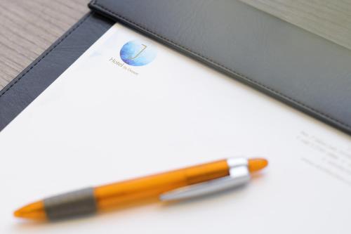 a pen sitting next to a notebook with a pencil at J-Hotel by Dorsett in Kuala Lumpur
