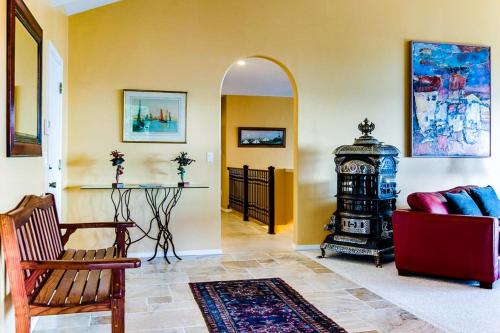 a living room with a red couch and a mirror at Hidden Luxury Beachfront Estate in Yachats