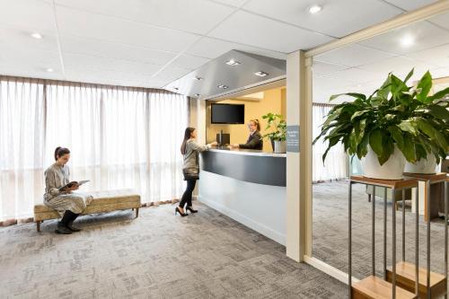 a lobby of a hospital with people waiting at a counter at Quest St Kilda Bayside in Melbourne