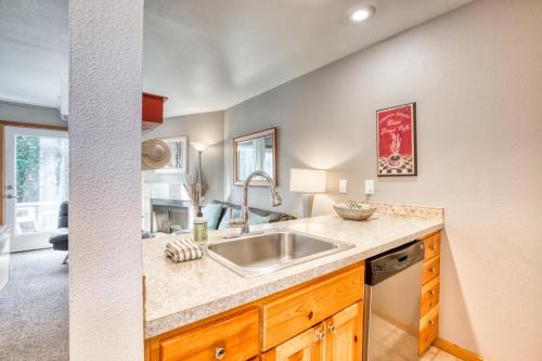 a kitchen with a sink and a living room at Beaches Inn | Sand Dune Townhouse in Cannon Beach