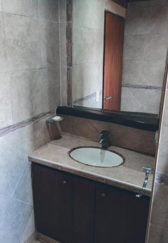 a bathroom with a sink and a mirror at Terra Nostra in Villa Ciudad de América