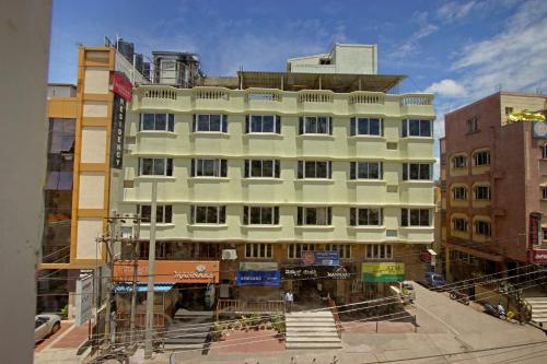 a building under construction on a city street at Mannars Residency in Mysore