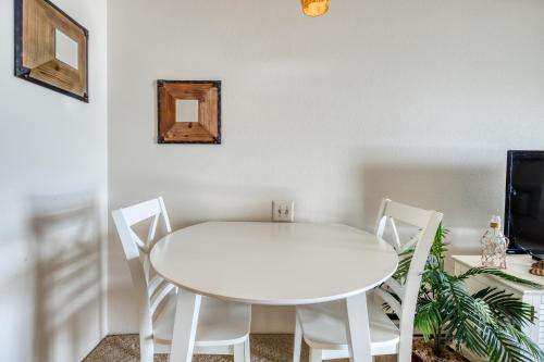 a white table and chairs in a room with a tv at Ocean Place in Ocean City