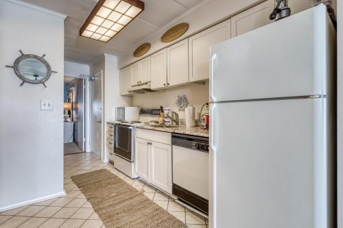 a kitchen with white cabinets and a refrigerator at Ocean Place in Ocean City