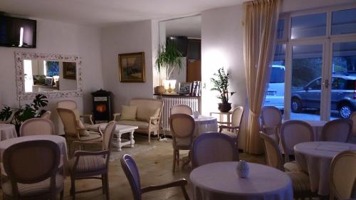 a room with tables and chairs and a room with a car at Hotel Riviera Panoramic Green Resort in Limone sul Garda