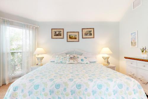 a bedroom with a large bed with two lamps at Harmony House in Anna Maria