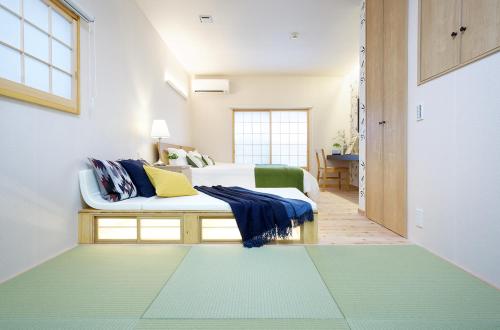 Кровать или кровати в номере SAKURANOMA