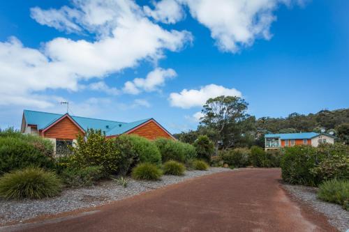 a road leading to a house with a blue roof at Banksia at Cosy Corner by the BNB Collection in Albany
