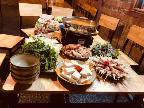a table with many different types of food on it at Meo Vac Cosy Hostel in Mèo Vạc