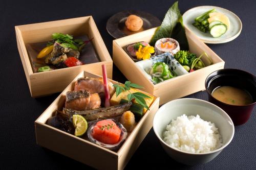 three boxes filled with different types of food on a table at Karuizawa Prince Hotel West in Karuizawa