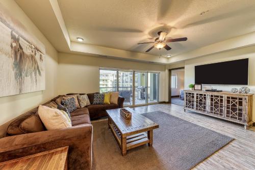 a living room with a couch and a flat screen tv at Estancia Enchantment in St. George