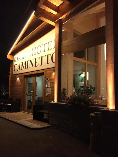 a hotel with a sign that reads call my hotel summit at Hotel Garnì Caminetto in Madonna di Campiglio