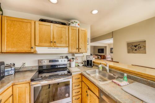 a kitchen with wooden cabinets and a stove top oven at Beautiful Mountain View Condo in Crested Butte