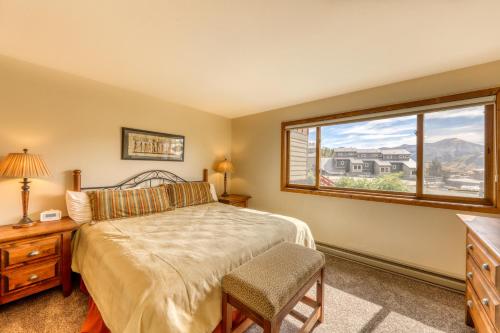 a bedroom with a bed and a window at Beautiful Mountain View Condo in Crested Butte