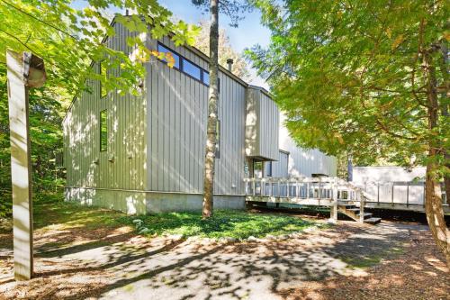 an exterior view of a building with a tree at Harbor Cove #9 in Harbor Springs