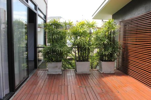 a balcony with potted plants in a building at Villa Thapae in Chiang Mai