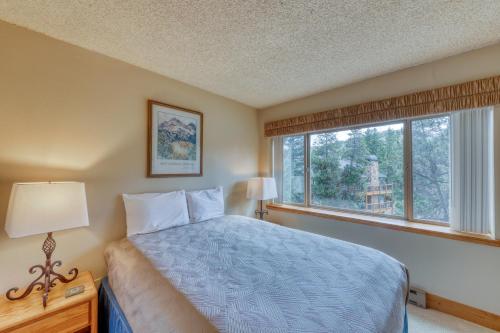 a bedroom with a bed and a large window at Powderhorn Corner & Vista in Breckenridge