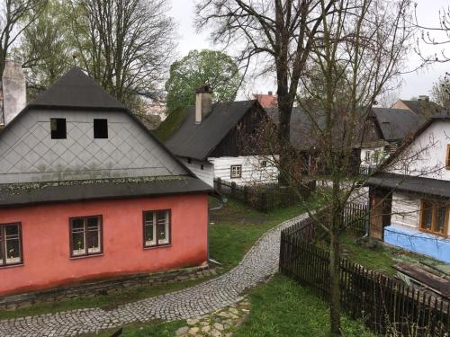 a group of houses in a village with a fence at Penzion Betlém in Hlinsko
