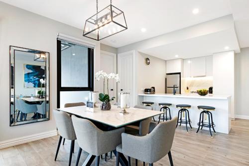 a kitchen and dining room with a table and chairs at Manhattan Apartments - Glen Iris in Melbourne