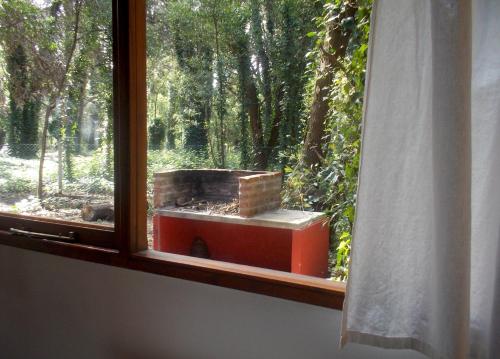 a window with a brick stove in a forest at Cabañas Las Sirenas in Mar del Plata