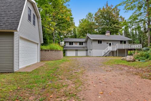 a house with a driveway and a garage at High Lake Hideaway in Boulder Junction