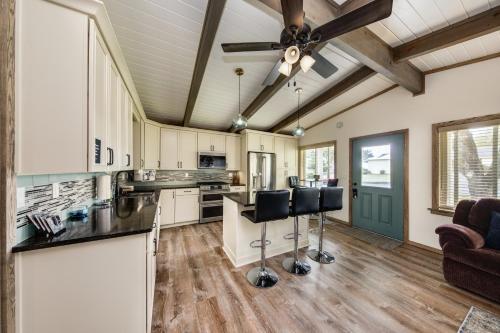 a kitchen with white cabinets and a ceiling fan at Wecoma Beach Retreat in Lincoln City