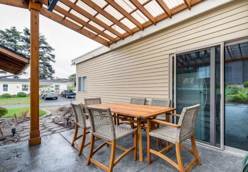 a wooden table and chairs on a patio at Wecoma Beach Retreat in Lincoln City