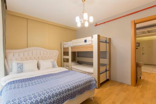 a bedroom with a bed and a bunk bed at CTS Elysium Residence Taksim in Istanbul