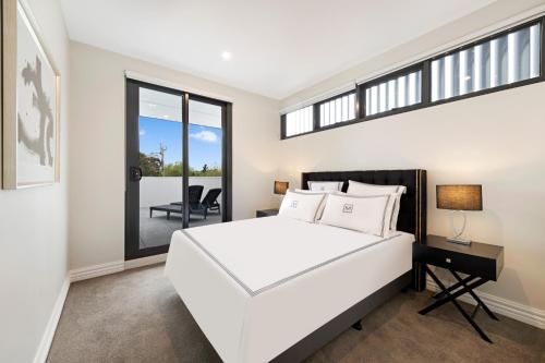En eller flere senge i et værelse på Manhattan Apartments - Glen Iris